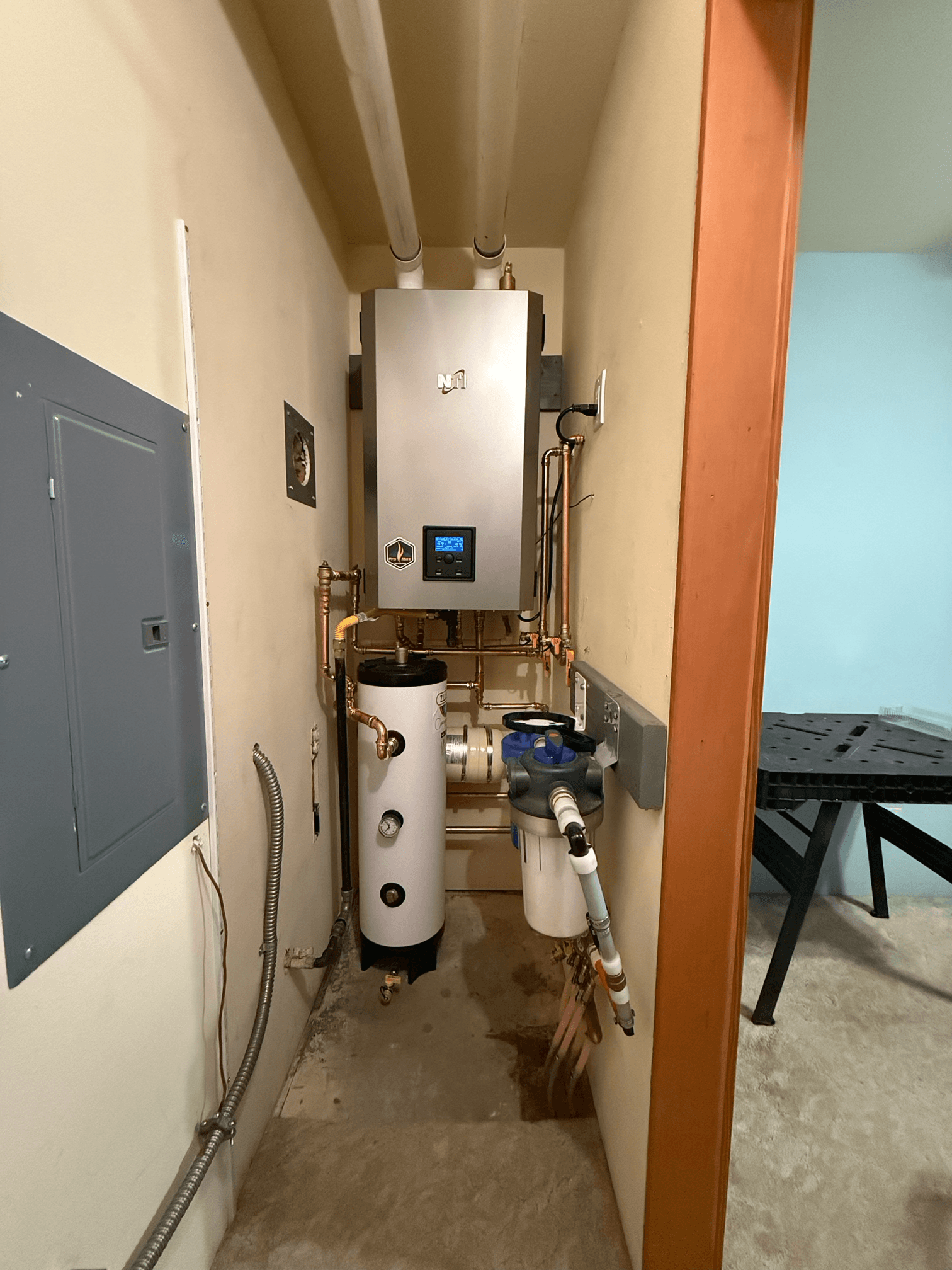 NTI Boiler and Indirect Water Heater Squeezed Into a Slim Utility Closet image